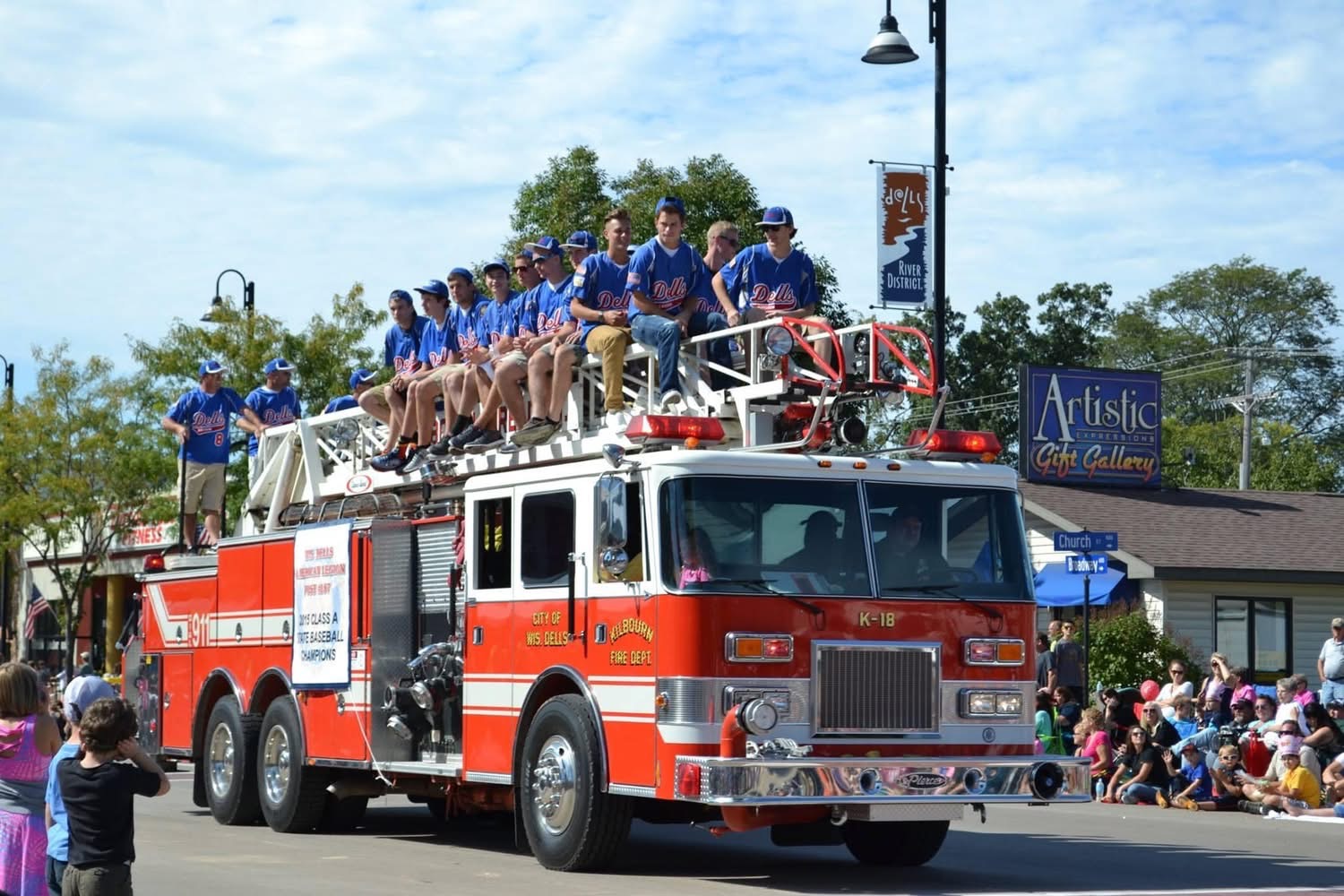 The Wisconsin Dells baseball team riding atop a firetruck in the parade