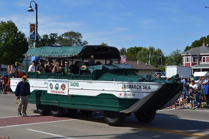 A vintage amphibious Wisconsin Duck carrying riders through the parade