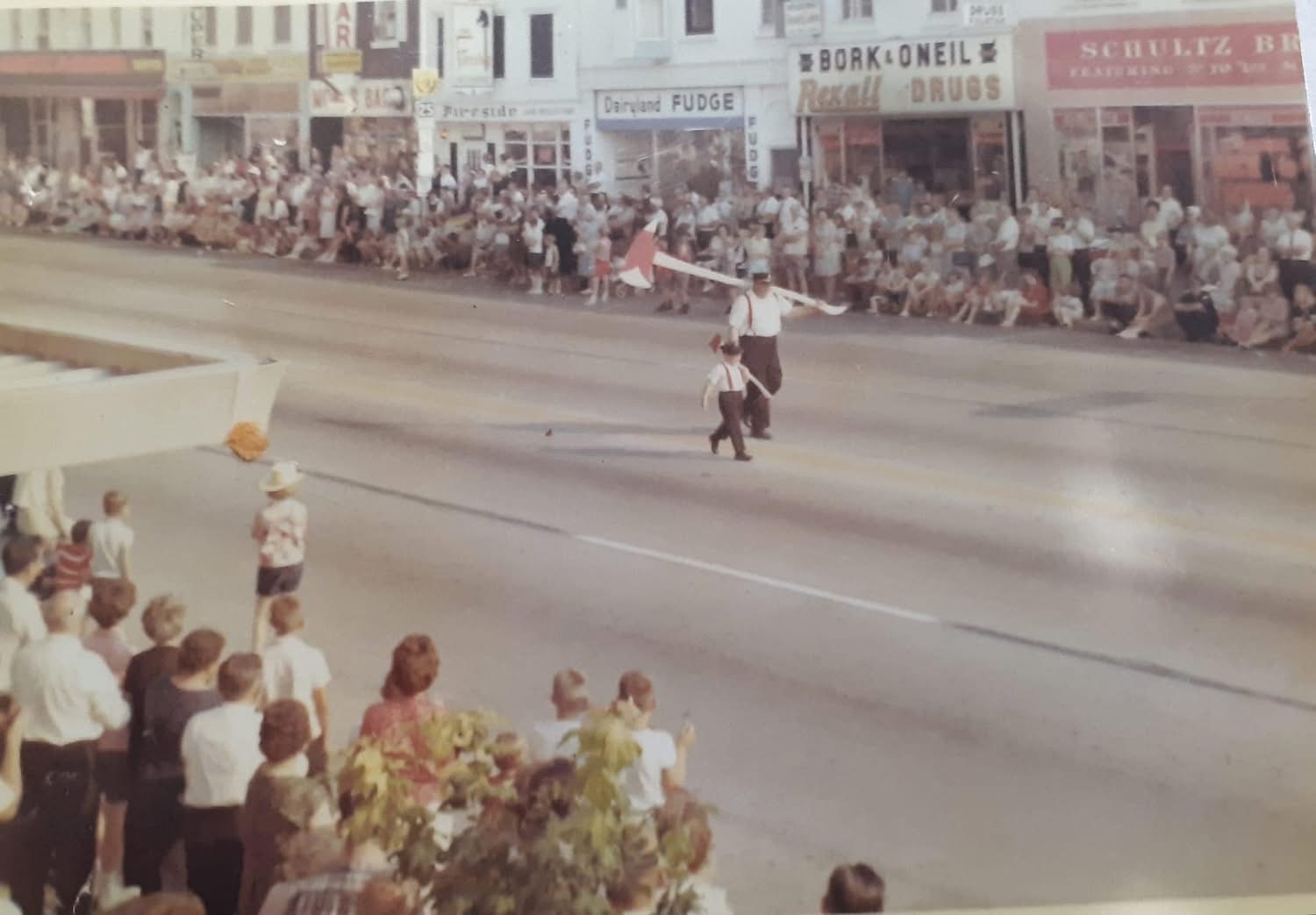A historic Wo-Zha-Wa parade traveling through downtown before a large crowd